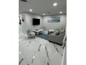 Living room features modern furnishings, a television, and bright, clean decor at 6220 Westport Dr, Port Richey, FL 34668