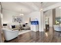 Bright living room features hardwood floors, modern furnishings, and a unique built-in fish tank display at 7876 Marsh Pointe Dr, Tampa, FL 33635