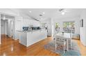 Bright kitchen with white cabinetry, stainless appliances, a breakfast bar and adjacent dining area with natural light at 79 Palm Dr, Placida, FL 33946