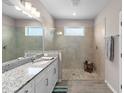 Bright bathroom featuring a glass-enclosed shower, granite countertops, and modern fixtures at 19891 Bridgetown Loop, Venice, FL 34293
