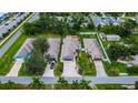 Expansive aerial view showcases a row of houses with manicured lawns, mature trees, and ample parking at 3369 Houle Ave, Sarasota, FL 34232