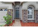 Welcoming front entrance with decorative stone pillars and a brick walkway at 11321 Flora Springs Dr, Riverview, FL 33579