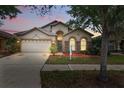 Beautiful home with a well-kept lawn, stone accents, and a two-car garage at 11321 Flora Springs Dr, Riverview, FL 33579