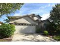 Exterior elevation showcases a two-car garage and stone detailing on the front facade at 11321 Flora Springs Dr, Riverview, FL 33579