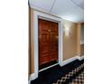 Condo entrance showcasing a rich wooden door with detailed hardware and unit number 3253 at 36750 Us Highway 19 # 21-301, Palm Harbor, FL 34684