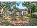 Attractive single-Gathering home with lush front yard and a large window in the front at 4822 W San Miguel St, Tampa, FL 33629