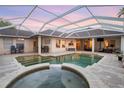 Gorgeous backyard pool and spa area with an outdoor kitchen and covered patio, ideal for outdoor living at 6020 Kestrel Point Ave, Lithia, FL 33547