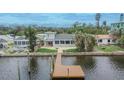 Relaxing backyard featuring a private wooden dock, perfect for enjoying waterfront views at 1022 Canal St, Ruskin, FL 33570