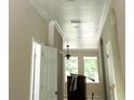 Bright hallway with white trim, recessed lighting, and arched doorway, offering a seamless flow between rooms at 422 Shannon Estates Ct, Plant City, FL 33563