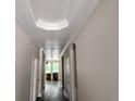 Bright hallway showcases crown molding, archways, and luxury vinyl plank flooring at 422 Shannon Estates Ct, Plant City, FL 33563