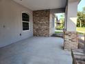 Covered entryway featuring brick accents and a window, perfect for enjoying the outdoors at 422 Shannon Estates Ct, Plant City, FL 33563