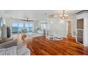 Bright living room with wood floors, water view, spiral staircase, and comfortable seating at 6423 Driftwood Dr, Hudson, FL 34667