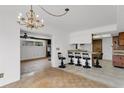 Eat-in kitchen features tile flooring, pendant lighting, and bar seating at 4902 Stolls Ave, Tampa, FL 33615
