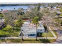 Charming single-story home with a covered porch, palm trees, and well-manicured lawn at 402 Pineapple St, Tarpon Springs, FL 34689