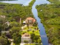 Stunning aerial view of the waterfront estate with manicured lawns and private boat dock with gulf access at 8731 Betty St, Port Richey, FL 34668