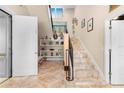 Grand entryway with decorative staircase, white shelving, and a tile floor that invites you inside at 8731 Betty St, Port Richey, FL 34668