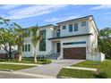 Eye-catching contemporary home with large windows, modern front door, and a well-maintained lawn at 5038 W Dickens Ave, Tampa, FL 33629