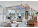 Bright living room featuring waterfront views, comfortable seating, and a ceiling fan at 16134 4Th E St, Redington Beach, FL 33708