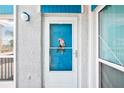 Charming front door detail, featuring an accent piece and ample sunlight at 343 Rex Pl # F, Madeira Beach, FL 33708