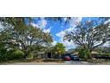 Charming single-story home featuring lush landscaping and mature trees, offering a serene curb appeal at 4553 31St E Ct, Bradenton, FL 34203
