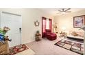 Cozy living room featuring comfortable seating, a ceiling fan, and bright natural light from the window at 534 19Th Nw St, Ruskin, FL 33570