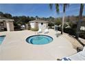 Inviting community hot tub with lounge chairs, ideal for relaxation and socializing at 1604 Boswell Ln, New Port Richey, FL 34655