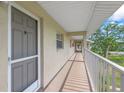 Hallway outside a condo unit with a view of palm trees at 3987 Maceachen Blvd # 133, Sarasota, FL 34233