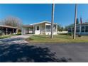 Inviting single-Gathering home featuring a carport, screened-in porch, and a well-maintained lawn at 5142 Serene Sq, New Port Richey, FL 34653
