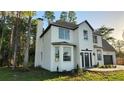 Side view of a well-maintained two-story home with new windows, and a new roof, and front entrance decor at 19018 Geraci Rd, Lutz, FL 33548