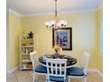 Cozy dining area features a round table with seating for four and decorative accents at 19417 Gulf Blvd # C210, Indian Shores, FL 33785