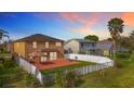 Spacious backyard with a covered patio, fenced yard, and potential for outdoor activities at 27500 Breakers Dr, Wesley Chapel, FL 33544