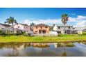 A view of the rear of the home showing a private yard, patio, and beautiful water view at 27500 Breakers Dr, Wesley Chapel, FL 33544