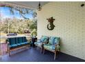 Cozy front porch with seating, brick accents, and charming mermaid artwork at 3333 San Bernadino St, Clearwater, FL 33759