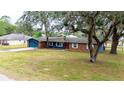 Charming single-story home with brick and siding, a long driveway, and mature trees at 36441 Lake Pasadena Rd, Dade City, FL 33525
