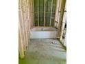 Bright bathroom construction showcases a new white tub set against framed wooden supports and a concrete floor at 10019 N Hyaleah, Tampa, FL 33617