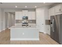 Bright, modern kitchen with stainless steel appliances and an expansive kitchen island at 12193 Meditation Trl, Venice, FL 34293