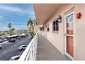 Inviting hallway with palm tree views and neutral tones, leading to units with secure doors at 6025 Shore S Blvd # 311, Gulfport, FL 33707