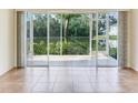 Spacious lanai area with tiled flooring, offering serene views of the lush backyard and waterfront at 6303 Green Oak Cir, Bradenton, FL 34203