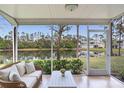 Relaxing screened patio with wicker furniture offers serene water views at 6303 Green Oak Cir, Bradenton, FL 34203