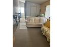 Bedroom featuring a loveseat, a queen sized bed, and bike parking at 12501 Ulmerton Rd # 140, Largo, FL 33774