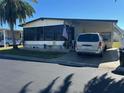 Charming home with a carport, mature landscaping, and well-maintained lawn at 12501 Ulmerton Rd # 140, Largo, FL 33774