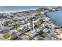Bright aerial view of a coastal neighborhood with colorful homes close to the beach and the bay at 18077 3Rd St, Redington Shores, FL 33708