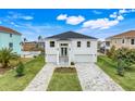 Stunning two-story white home featuring a double garage and landscaped front yard at 3431 Palometa Dr, Hernando Beach, FL 34607