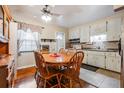 Eat-in kitchen with wooden dining table, wood floors, and white cabinets at 5927 3Rd N Ave, St Petersburg, FL 33710