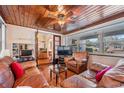 Relaxing sunroom with wood ceiling, large windows, comfortable seating, and view to the front yard at 5927 3Rd N Ave, St Petersburg, FL 33710