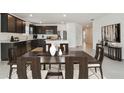 Beautiful kitchen with dark cabinets, stainless steel appliances, and a large center island at 12815 Wanderlust Pl, Parrish, FL 34219