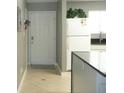 Kitchen and entrance featuring light colored ceramic tile, entry door, and white appliances at 6033 34Th W St # 45, Bradenton, FL 34210