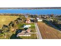 Panoramic aerial view of properties near a serene blue lake, highlighting the neighborhood and water access at 10920 Flint Estates Dr, Thonotosassa, FL 33592