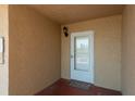 This is the entrance to the condo, with a well-lit entryway and a welcoming doormat at 19451 Gulf Blvd # 204, Indian Shores, FL 33785