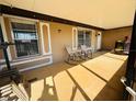Enclosed patio featuring neutral colors, decorative windows, and relaxing rocking chairs at 27064 Omni Ln, Punta Gorda, FL 33983